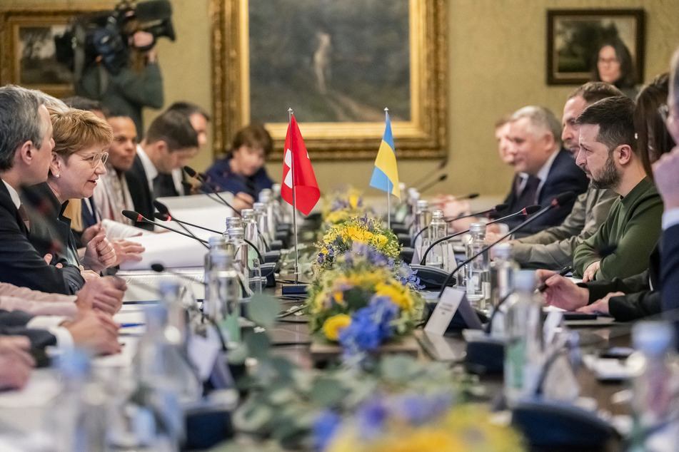 Swiss President Viola Amherd (c-l) and Ukraine's President Volodymyr Zelensky (c-r) hold bilateral talks with their delegations in Kehrsatz near Bern, Switzerland, on Monday.