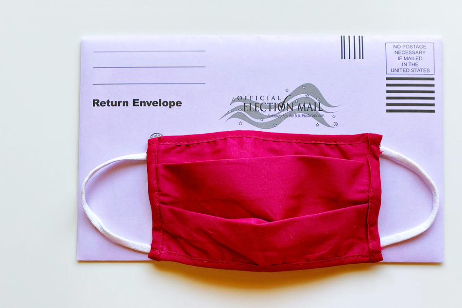 An official mail-in ballot with a cloth mask.