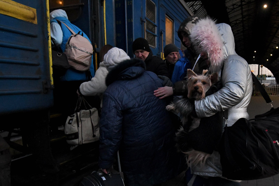 Refugees fleeing the Russian invasion in Ukraine evacuated through a train station in Lviv on Tuesday. The refugee exodus is the largest in Europe since WWII.