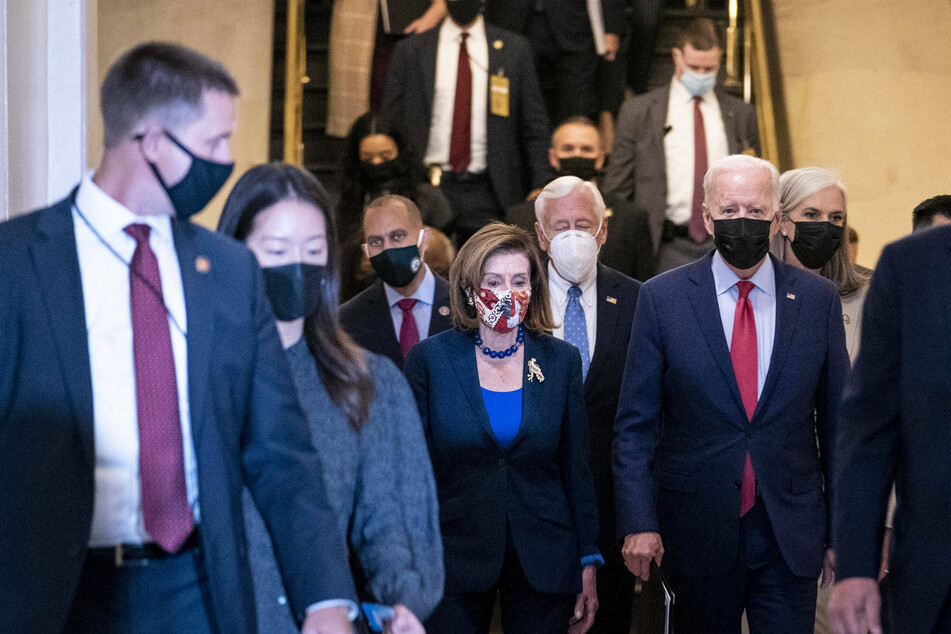 House Speaker Nancy Pelosi escorts President Joe Biden to meet with the House Democratic Caucus to discuss the $1-trillion infrastructure plan.
