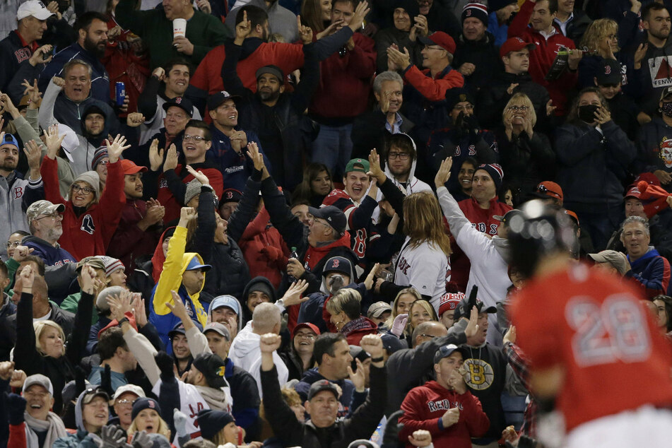 Red Sox fans celebrate after their team took a 2-1 ALCS lead on Monday night.