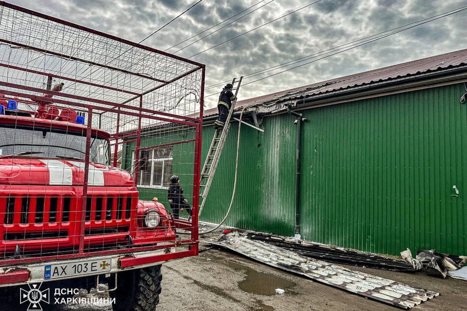 Emergency personnel work at the site of a Russian drone strike, as Russia and Ukraine accused each other of breaching the 32-hour ceasefire, in the town of Zolochiv in an image released on April 12, 2026.