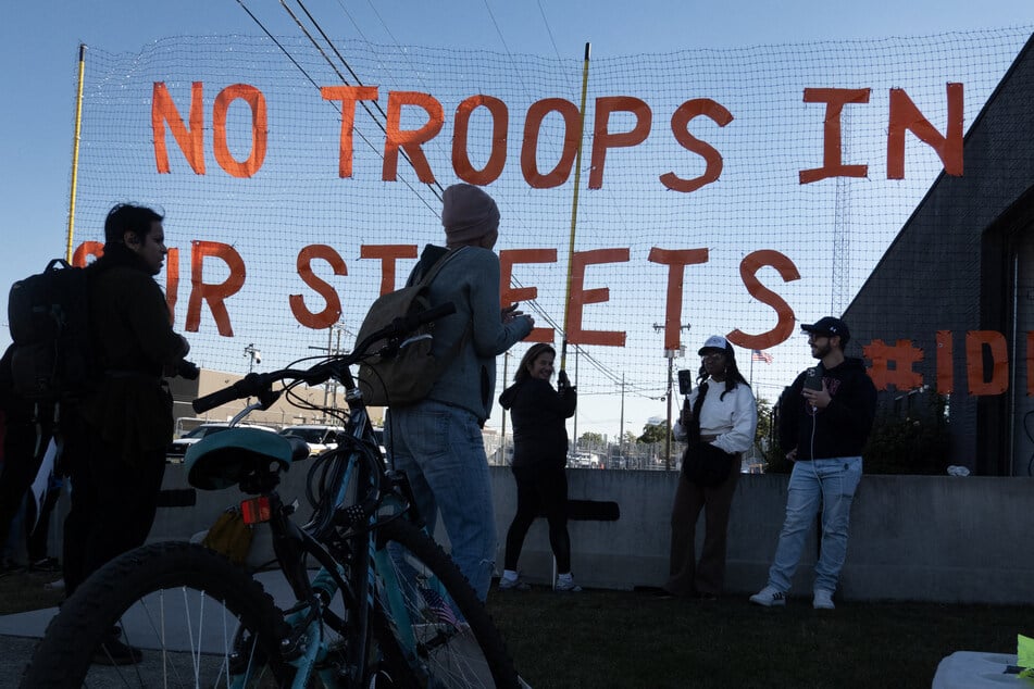 Demonstrators protest in the "Free Speech Zone" outside of the immigration processing and detention facility in Broadview, Illinois, on October 9, 2025.
