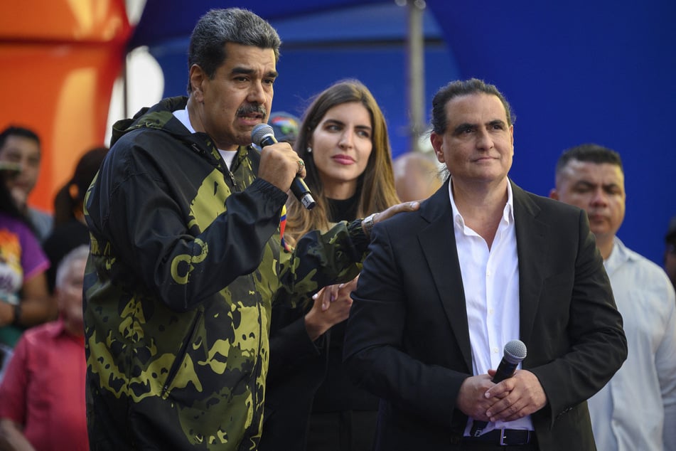 Venezuela's President Nicolas Maduro (l.) speaks to supporters next to Colombian-born businessman Alex Saab during a rally in support of his government in Caracas on January 23, 2024.
