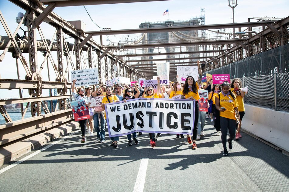 Thousands of demonstrators marched across the Brooklyn Bridge to Foley Square in NYC on Saturday to stand against the Texas abortion ban and show their support for women s rights, before marching to Washington Square Park.