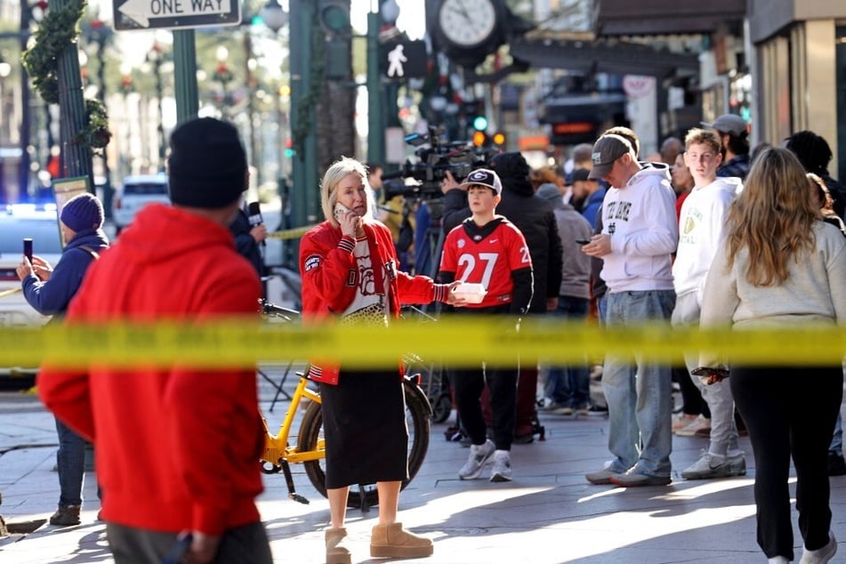 Fans from both Notre Dame and Georgia in town for the Sugar Bowl watch the investigation in the French Quarter after at least 10 people were killed in a truck-ramming attack.