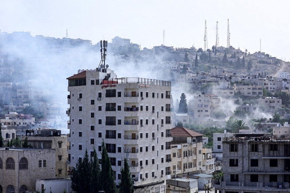 Smoke billows during a raid by Israeli forces in the Jenin refugee camp in the occupied West Bank on May 21, 2024.