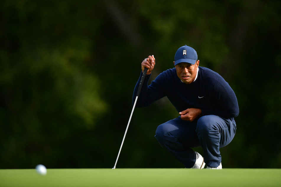 Tiger Woods lines his putt on the twelfth green during the first round of The Genesis Invitational golf tournament.