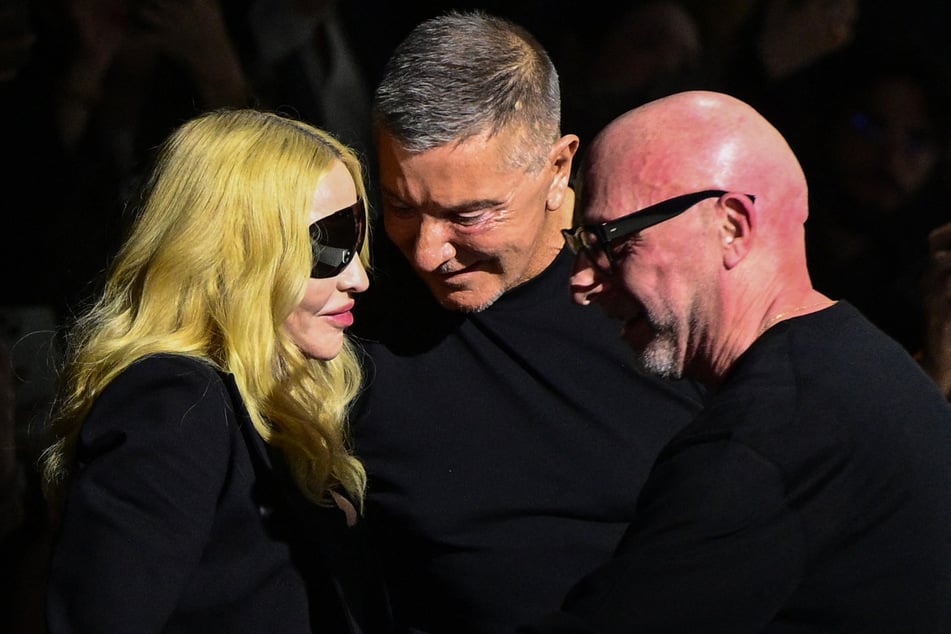 Madonna (l) was welcomed by Italian stylists Domenico Dolce (r.) and Stefano Gabbana after the show.
