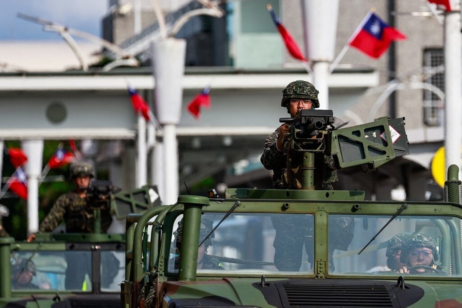 Taiwanese military vehicles patrol outside Songshan Airport in Taipei.