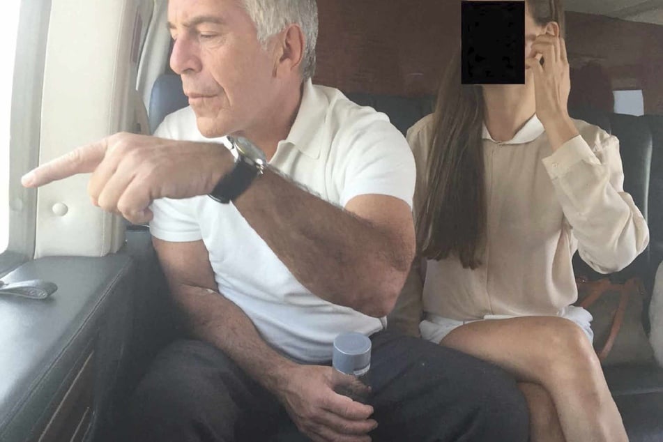 This undated and unlocated handout image released by Democrats on the House Oversight Committee on December 18, 2025, shows late convicted sex offender Jeffrey Epstein (L) sitting next to a woman whose face has been redacted.