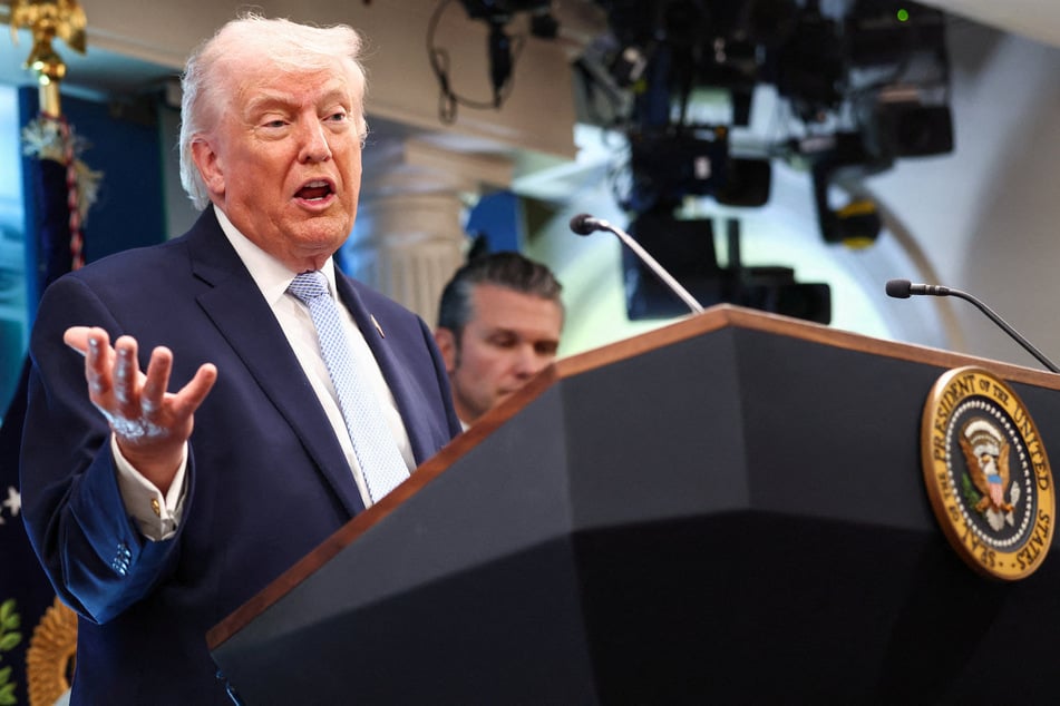 President Donald Trump, flanked by Secretary of Defense Pete Hegseth, speaks during a press conference at the White House on April 6, 2026.