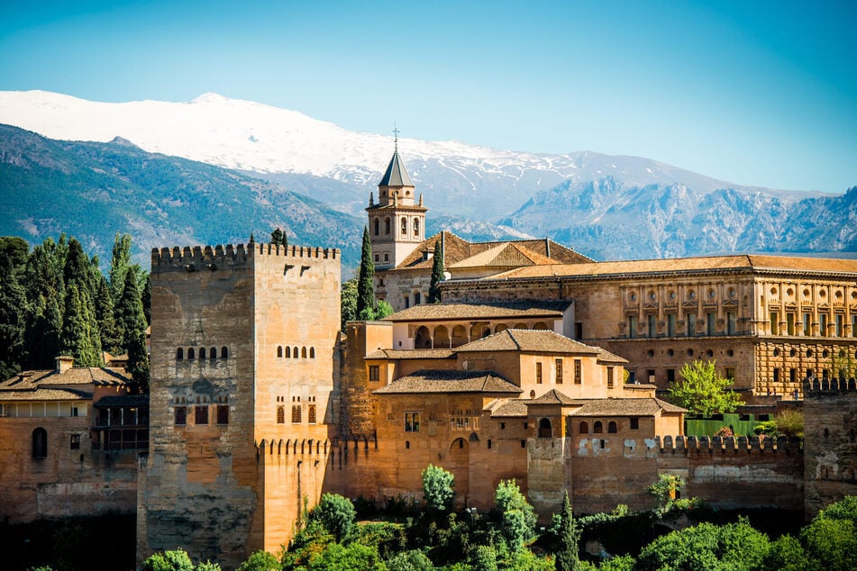 Geschichte pur: Die berühmte Alhambra in Granada ist eine prachtvolle mittelalterliche Stadtburg. Im Hintergrund thronen die Gipfel der Sierra Nevada.