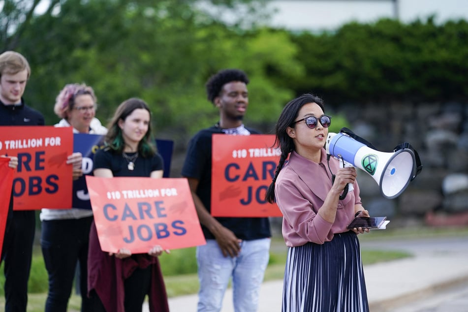 Wisconsin state Representative Francesca Hong (r.) speaks at a rally in Madison calling on the Biden administration and Congress to support $10 trillion in investments for climate, care, jobs, and justice on June 8, 2021.