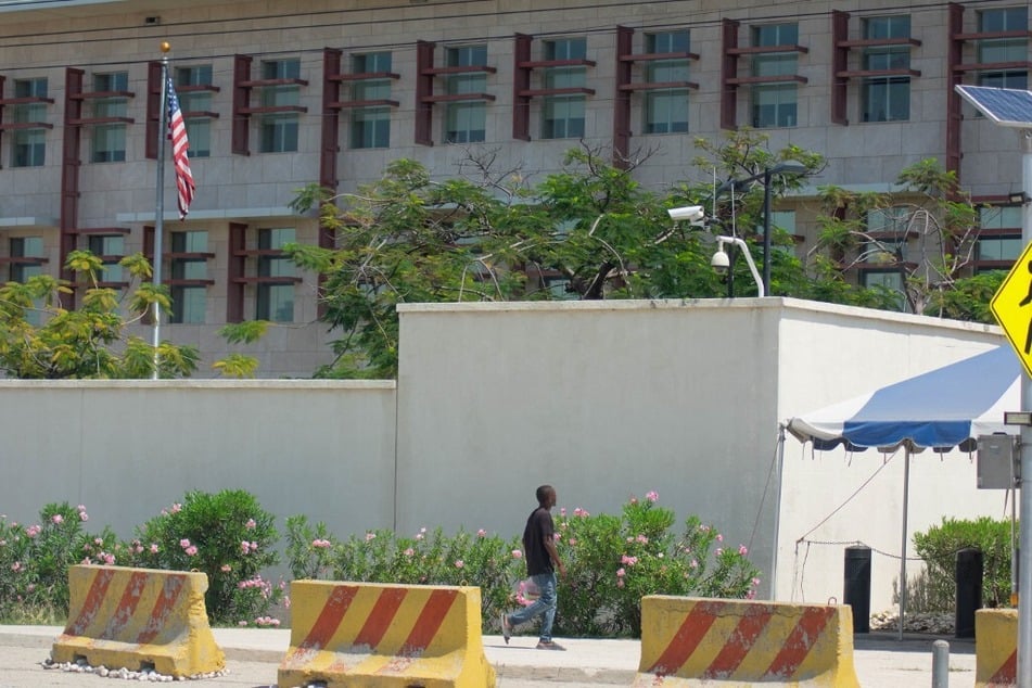 A man walks past the US embassy in Port-au-Prince, Haiti.
