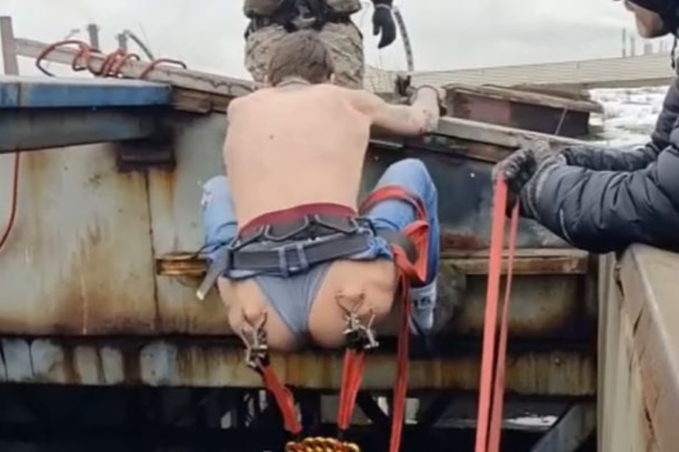 This Russian bungee jumper leapt off the side of a 50-foot building with ropes attached to his bum piercings!
