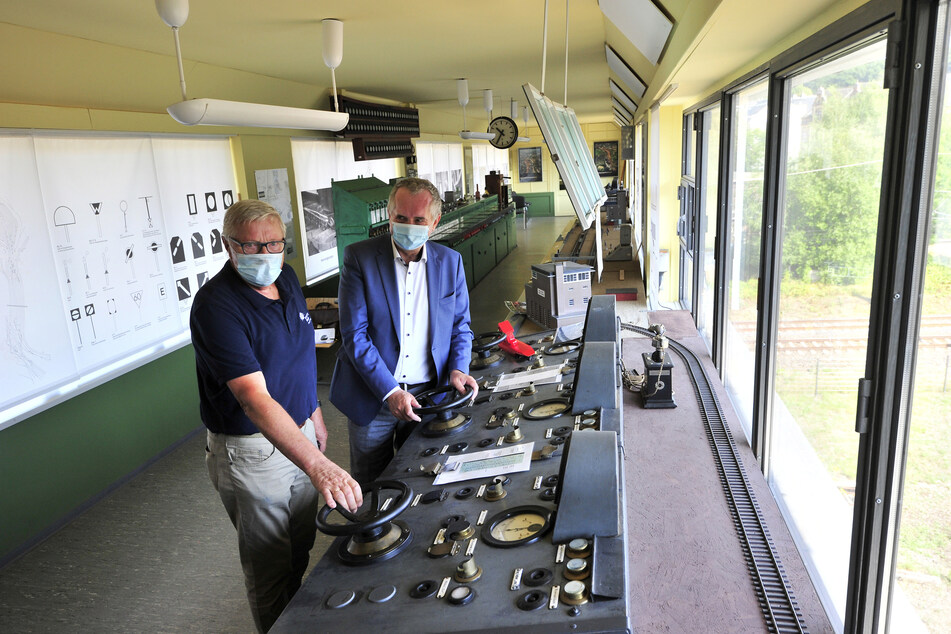 Manfred Vogel (76, l.) und Thomas Schmidt (59, CDU) drehen im Befehlsstellwerk 3 in Hilbersdorf an einem Bedienpult gemeinsam am Rad.