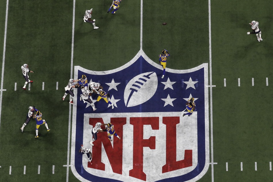 Das Logo der National Football League (NFL) auf einem Rasen, während ein Spiel ausgetragen wird.
