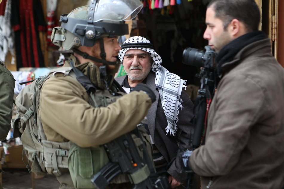 Israeli soldiers forced Palestinian shops to close, while settlers threw rocks at shopkeepers and passersby in the West Bank city of Hebron on January 29, 2022.