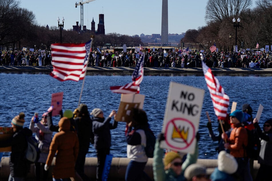 People take part in a "Not My Presidents Day" protest against Donald Trump in Washington DC on February 17, 2025.