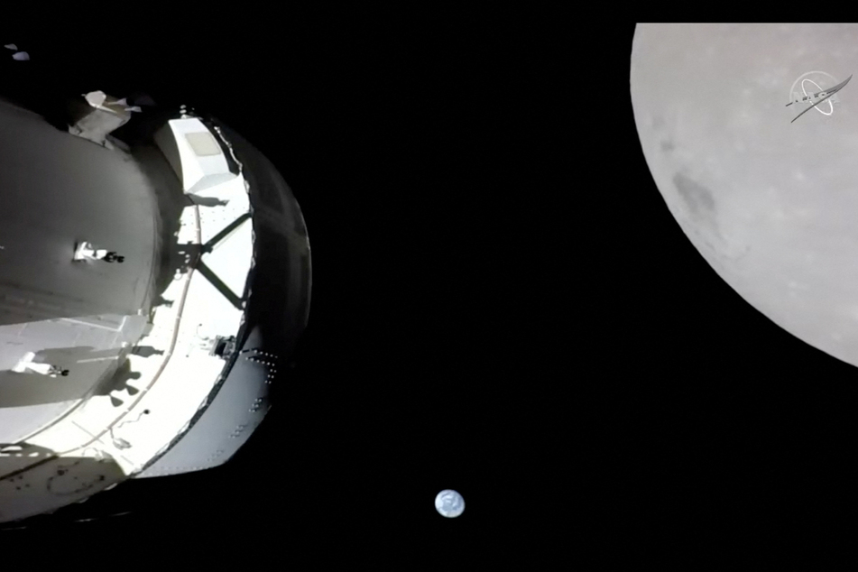 A camera on Orion's solar array wing captures a view of the spacecraft, the Earth, and the Moon during the outbound powered flyby of the Moon as part of the Artemis I mission.