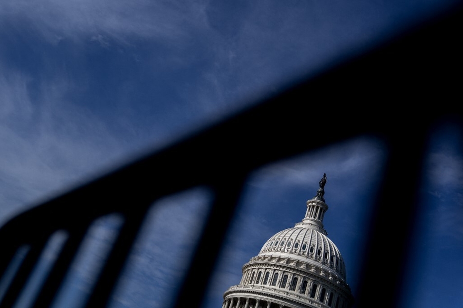 The US Capitol is seen through a police barricade in Washington DC.