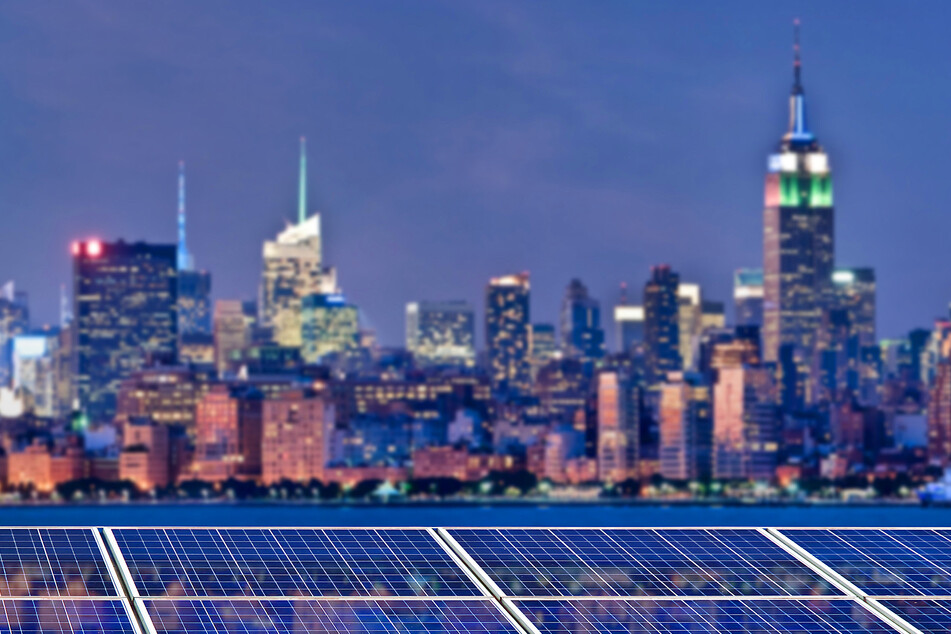 Solar panels in front of the New York skyline.
