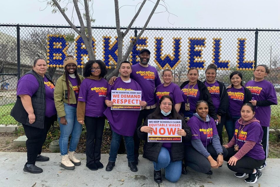 LAUSD school workers hold signs demanding fair wages and respect on the job.