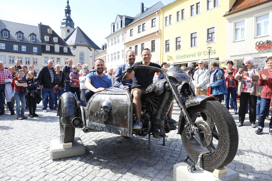Schrott-Motorrad auf dem Zschopauer Neumarkt (v.l.): Thomas Stanzel, Oberbürgermeister Arne Sigmund und Robert Hähnel weihten den "Ghost Rider" ein.