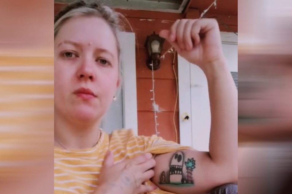 TikTok user th3victorygarden shows off her tattoo.