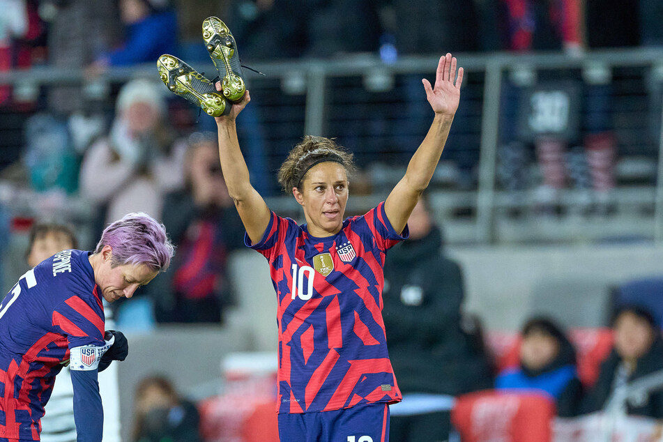 United States forward Carli Lloyd (c) waves to fans after playing her final international game on Tuesday night.