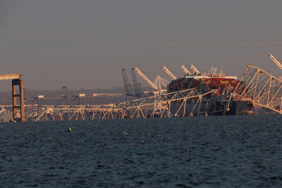 The container ship is still tangled with the ruins of the bridge as authorities investigate a possible power failure.