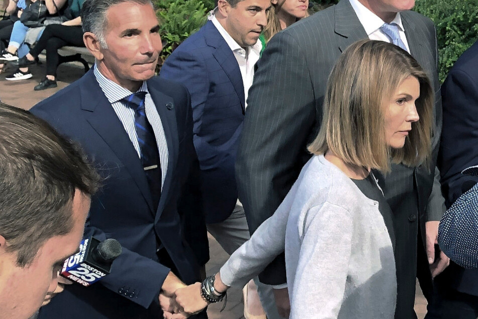 US actor Lori Loughlin leaves the Federal Court with her husband Mossimo Giannulli (l), a fashion designer.