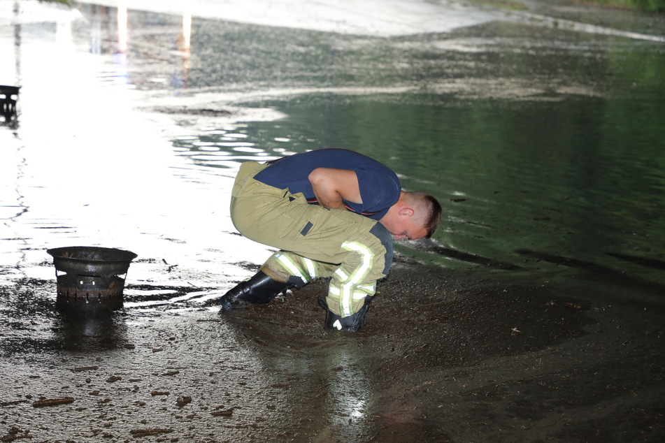 Die Kameraden der Feuerwehr mussten die verstopften Gully-Deckel anheben, damit die Wassermassen abließen konnten.