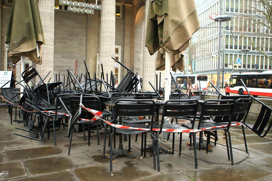 A tape surrounding chairs and tables at a Starbucks, emblematic for the "new normal" of the pandemic.