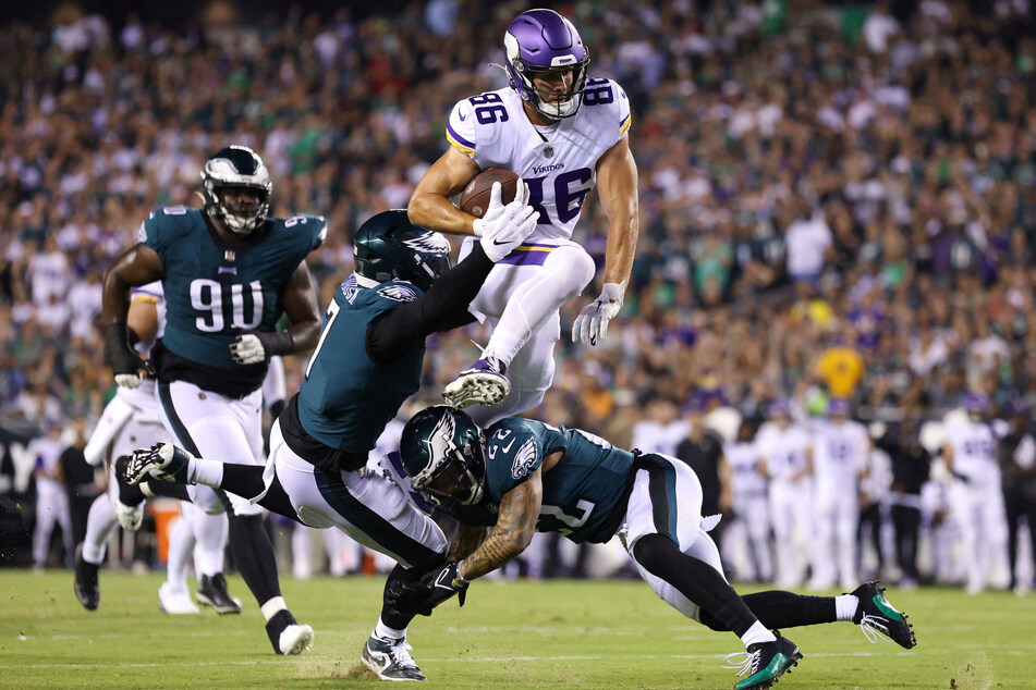 Minnesota Vikings tight end Johnny Mundt (top c.) leapt over Philadelphia Eagles linebacker Haason Reddick and safety Marcus Epps (bottom r.) after a catch during the second quarter at Lincoln Financial Field on Monday.