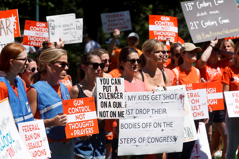 Protesters hold signs calling for greater gun control at the March Fourth rally.