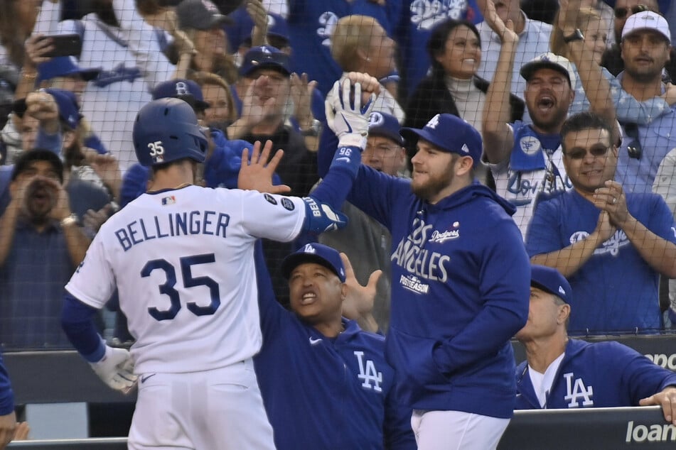 Cody Bellinger (l) and the Dodgers won game three of the NLCS, cutting Atlanta's series lead to 2-1.