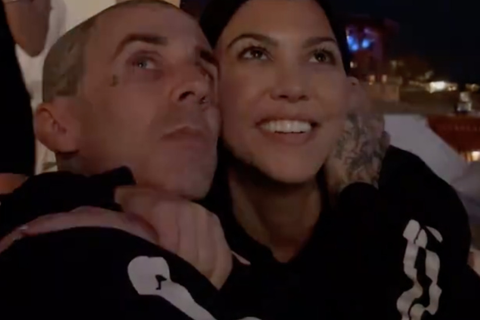 Kourtney Kardashian and Travis Barker were all smiles while enjoying a fireworks show in Cabo, Mexico.