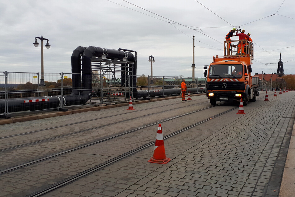 DVB-Mitarbeiter inspizieren die verschlissene Fahrleitung in stadtauswärtiger Richtung auf der Augustusbrücke.