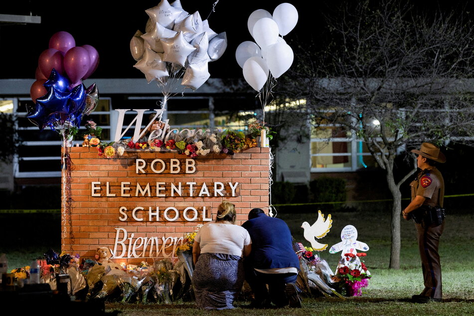 Mourners pay their respects at a makeshift memorial outside Robb Elementary School in Uvalde, Texas.