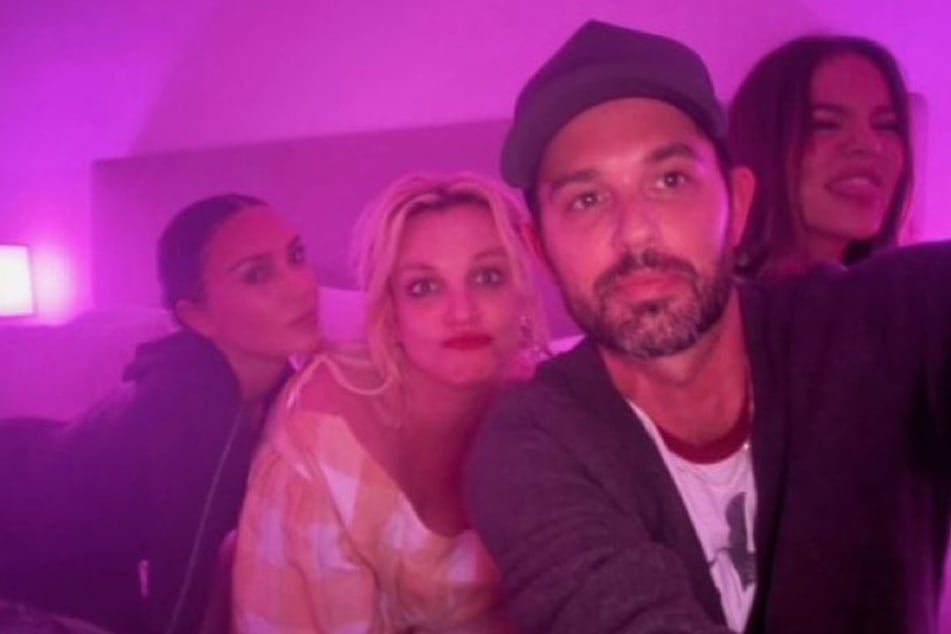 Kim Kardashian (l.) revealed how Britney Spears (c.) "ended up in bed" with her and Khloé (r.) during their viral sleepover with the pop star.