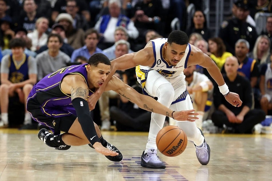 Like two brothers playing basketball, Warriors' Jordan Poole and Los Angeles Lakers' Juan Toscano-Anderson tussled for a loose ball during the third quarter of the 2022-23 season opener.