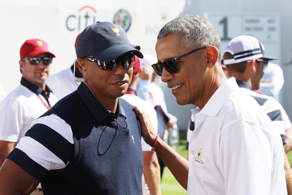 Captain's assistant Tiger Woods (l.) of the US Team speaks to former US President Barack Obama (r.) on the first tee during Thursday foursome matches of the Presidents Cup at Liberty National Golf Club on September 28, 2017 in Jersey City, New Jersey.