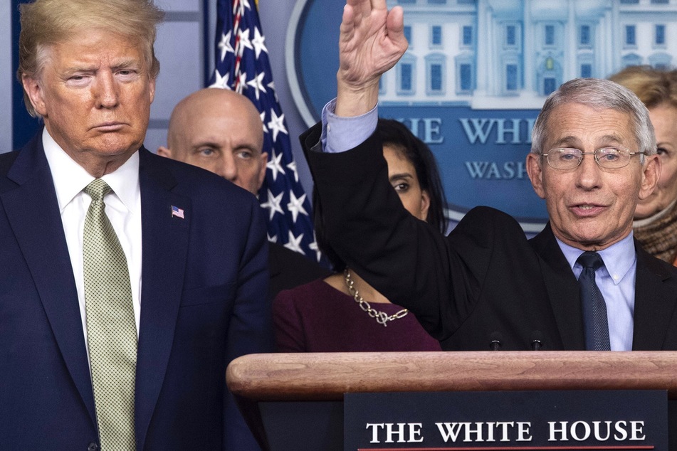 President Donald Trump looking on as Dr. Anthony Fauci speaks at the White House.