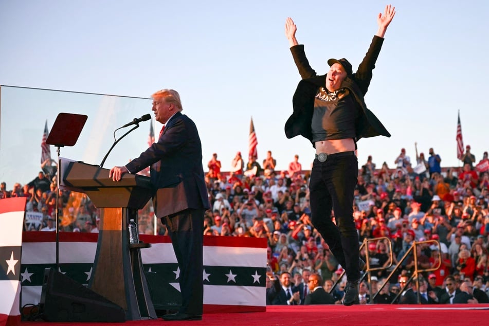 Billionaire Elon Musk (r.) jumping with joy as Donald Trump introduces him during a campaign rally in Butler, Pennsylvania on October 5, 2024.