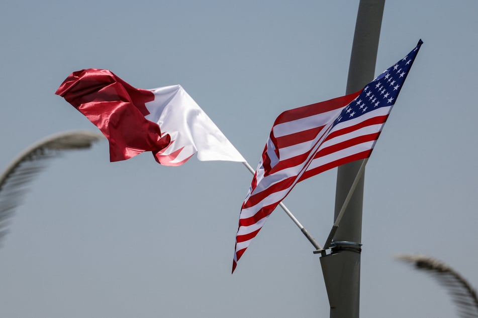 American and Qatari flags are seen on a lamppost in Doha ahead of a visit by President Donald Trump.