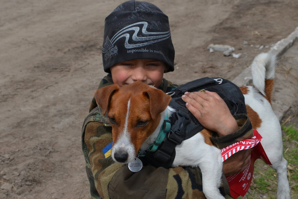 Patron poses with a child in Chernihiv.