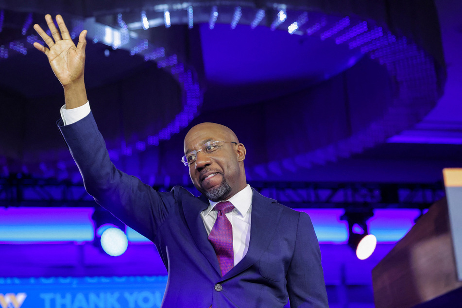 Democrat Raphael Warnock celebrates his win over Republican candidate Herschel Walker in the Georgia Senate runoff.