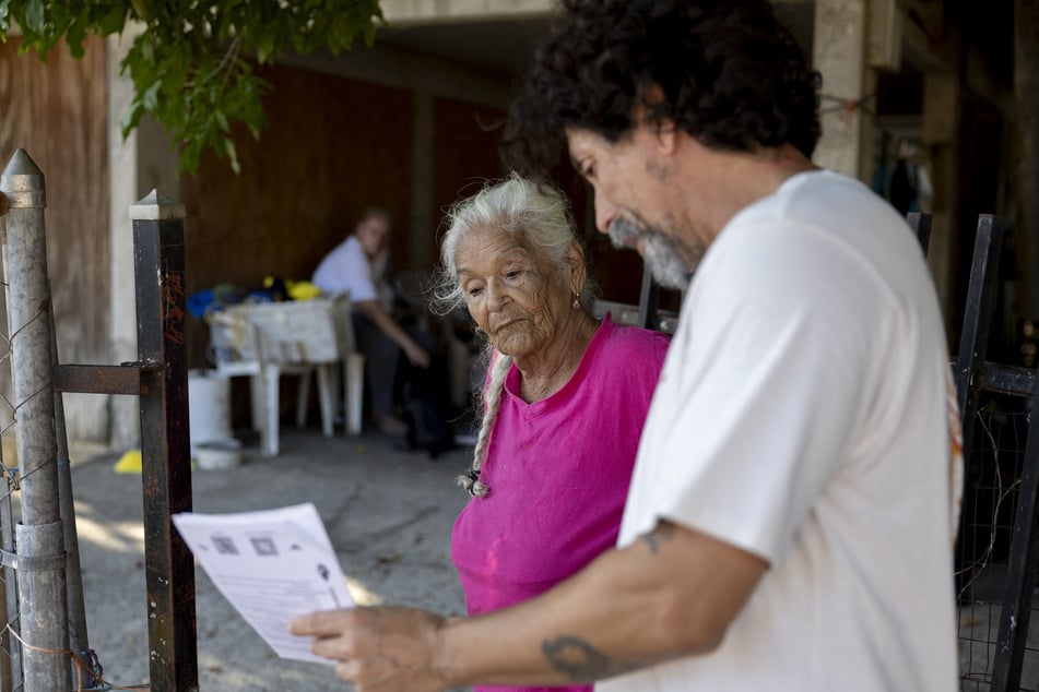 Braulio Quintero, with a coalition of groups opposing the construction of the mega project Esencia, talks to Mayra Perez Montalvo about how the project is going to affect the locals in Cabo Rojo, Puerto Rico, on July 15, 2025.